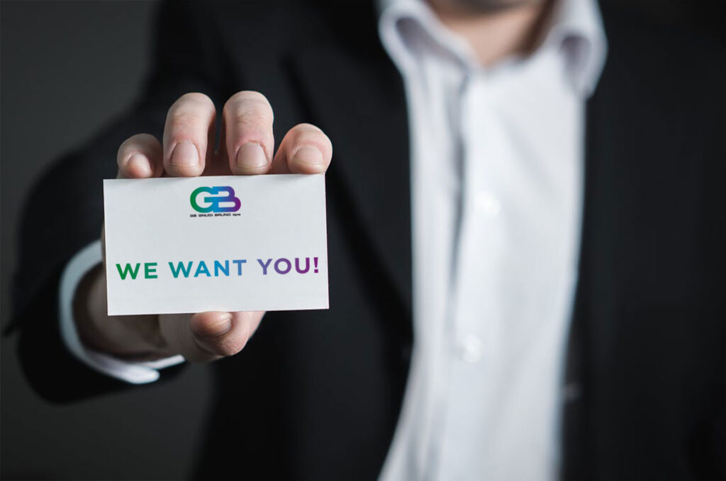 Business man con biglietto da visita in mano con logo GB Gnudi e scritta We Want You